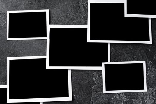 Paper photo frames with blank space on gray textured background