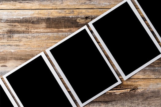 Blank photo frames for your photos on wooden background