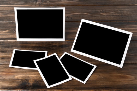 Blank photo frames for your photos on wooden background