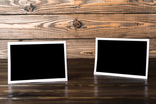 Blank photo frames for your photos on wooden background