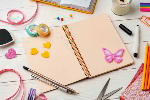 Creative workspace with colorful stationery and decorations on a white wooden desk photo