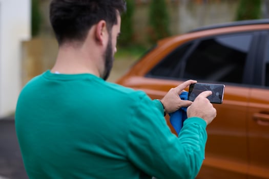 Capturing the Moment. A Man Photographs His Car for Sale to Share Online photo