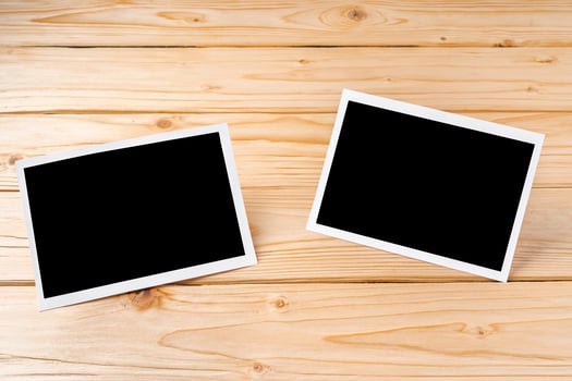 Blank photo frames for your photos on wooden background