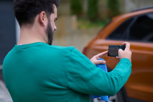 Capturing the Moment. A Man Photographs His Car for Sale to Share Online photo