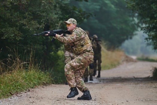 A disciplined and specialized military unit, donned in camouflage, strategically patrolling and maintaining control in a high-stakes environment, showcasing their precision, unity, and readiness for photo