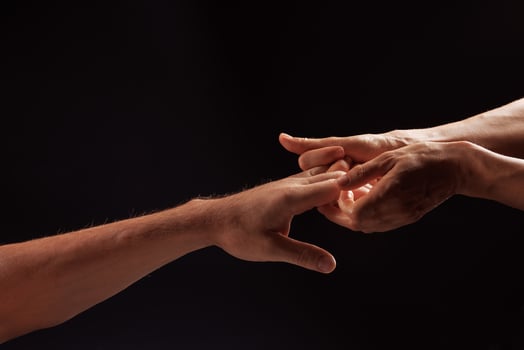 girl masseur doing hand massage to man on dark background close-up, beautiful relaxation massage photo