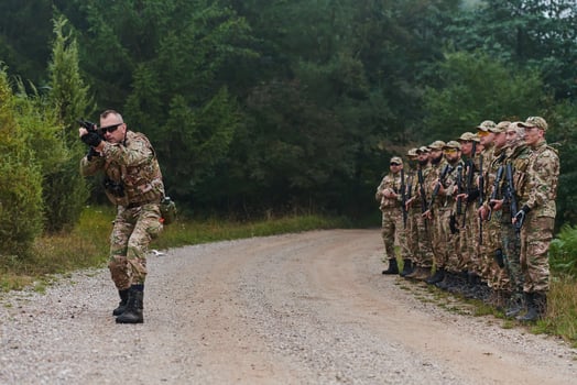 A major imparts precise military instructions to his elite unit, embodying strategic leadership as they gather for a briefing on tactical maneuvers and disciplined coordination photo