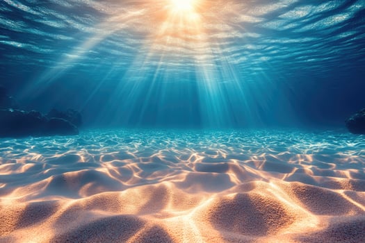 Sun shining on idyllic sandy seabed underwater ocean scene photo