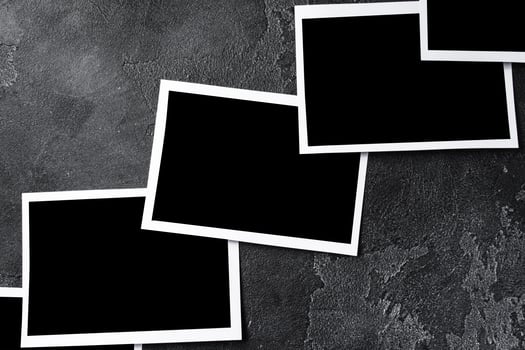 Paper photo frames with blank space on gray textured background