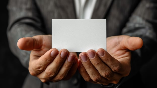 A man is holding a white business card in his hand photo