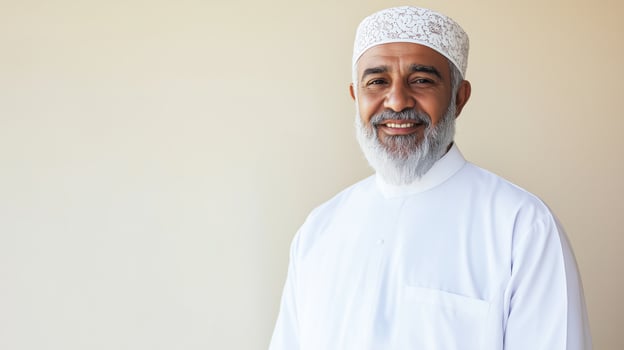 Portrait of a MiddleAged Sunni Muslim Cleric of Indian Heritage in Traditional White Attire, Smiling photo