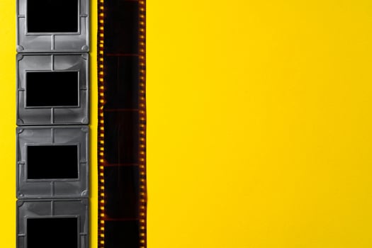 Photography empty slide frames on yellow background photo