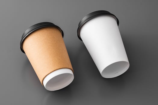 Two paper takeout coffee cups on gray background photo
