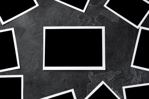Paper photo frames with blank space on gray textured background