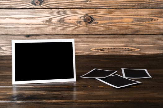 Blank photo frames for your photos on wooden background