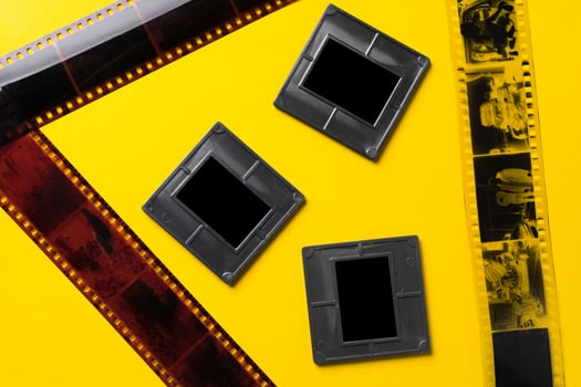 Photography empty slide frames on yellow background photo