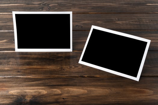 Blank photo frames for your photos on wooden background