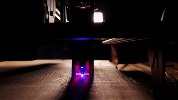 The process of laser wood cutting. A laser machine precisely carves lines on the surface, creating detailed and accurate designs. Perfect for themes of high-tech and manufacturing photo