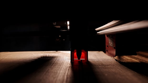 The process of laser wood cutting. A laser machine precisely carves lines on the surface, creating detailed and accurate designs. Perfect for themes of high-tech and manufacturing photo