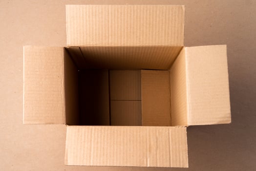 Cardboard box on beige background in studio photo