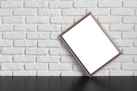 Blank picture frame against brick wall with copy space photo