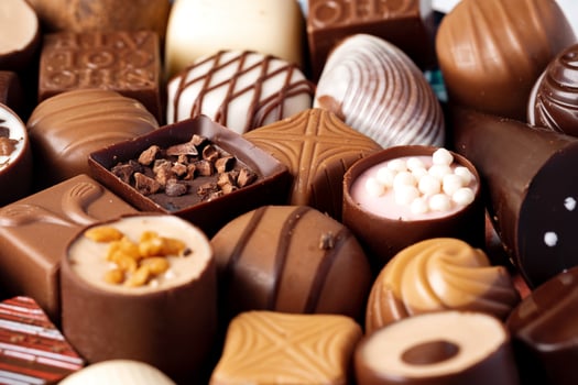 Various chocolate praline candies assortment close up photo