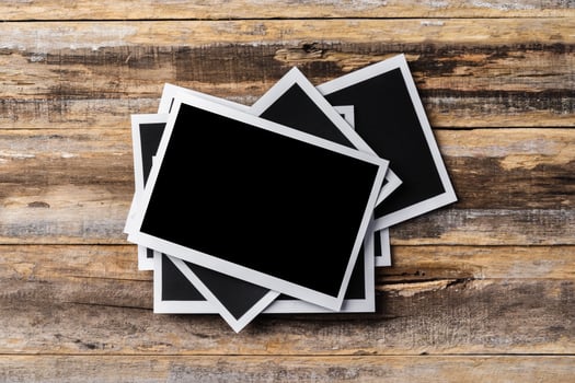 Blank photo frames for your photos on wooden background