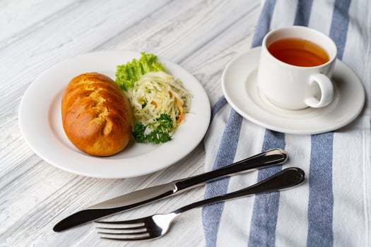 Traditional Russian pie or patty on white plate photo