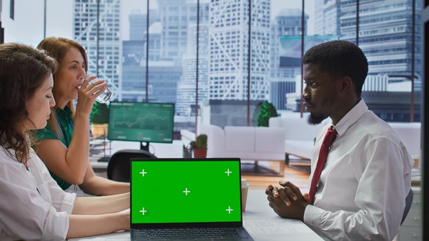 Interviewers meeting with a job candidate about a vacancy next to green screen, HR team attending interview with applicant during recruitment process. Headhunting concept. Camera B. photo