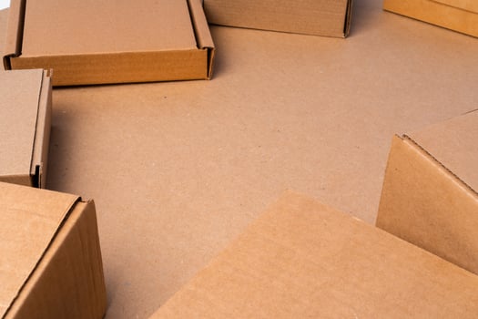 Cardboard box on beige background in studio photo
