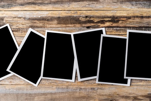 Blank photo frames for your photos on wooden background