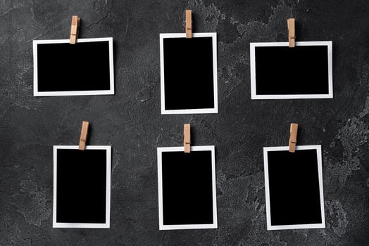 Paper photo frames with blank space on gray textured background