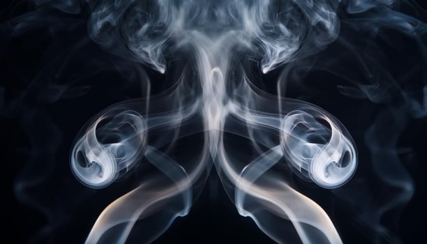 An abstract image of swirling white smoke against a dark background, creating intricate, symmetrical shapes and ethereal patterns. photo