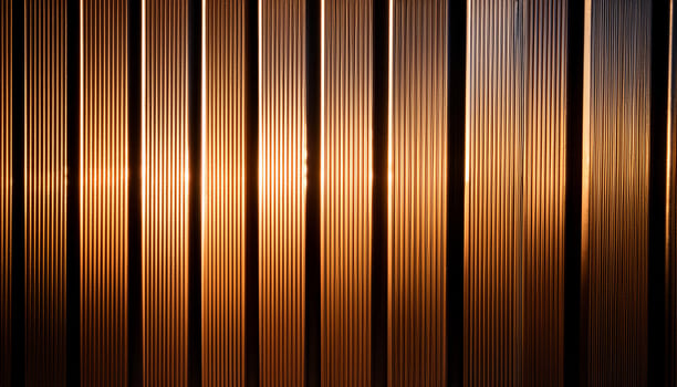 Close-up of vertical metal lines illuminated by warm golden light, creating a modern, industrial, and textured pattern. photo