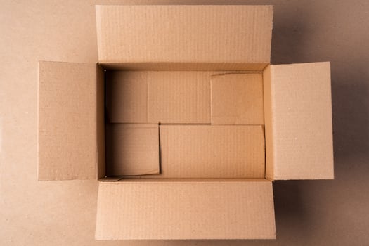 Cardboard box on beige background in studio photo