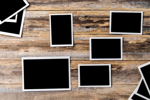 Blank photo frames for your photos on wooden background