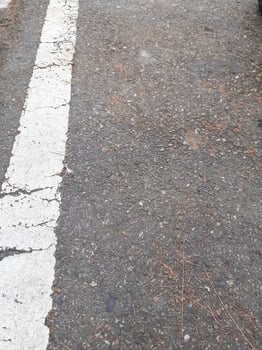 Perspective view of asphalt road texture with white markings on the left side. Copy space concept. asphalt texture and straight road lines photo