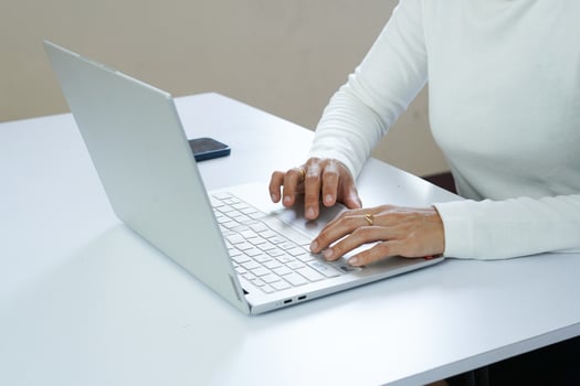 Close up of woman's hands typing on a laptop. Working concept photo