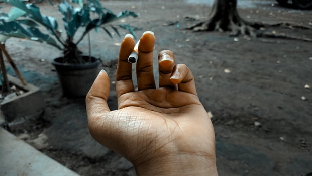 A person holding a cigarette in their hand photo