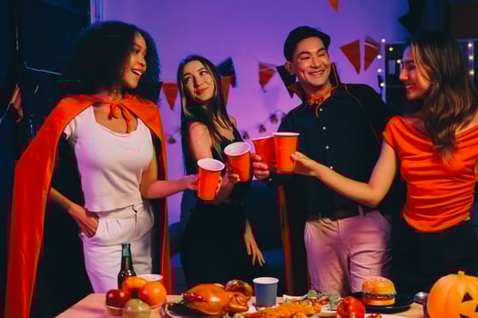Joyful office Halloween party with coworkers in costumes, celebrating with drinks and laughter, fostering teamwork and festive spirit photo
