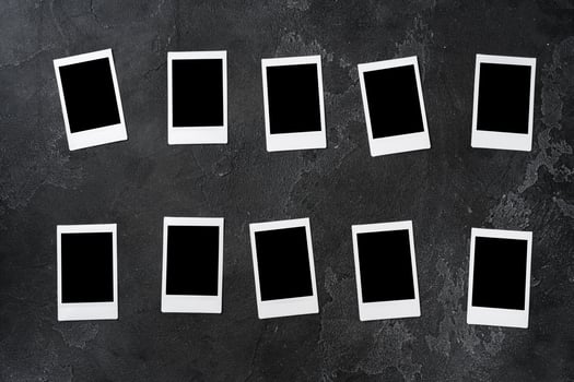 Paper photo frames with blank space on gray textured background