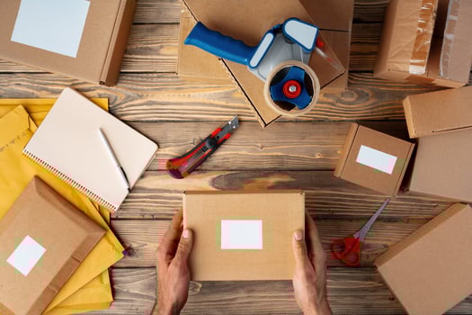 Packing products for delivery on wooden table, top view photo