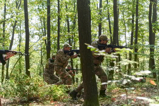A specialized military antiterrorist unit conducts a covert operation in dense, hazardous woodland, demonstrating precision, discipline, and strategic readiness photo