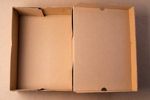 Cardboard box on beige background in studio photo