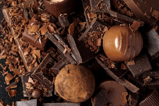 Grated chocolate and pieces of tasty chocolate on table photo