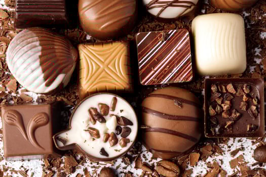 Chocolate candies and chocolate pieces pile for background photo