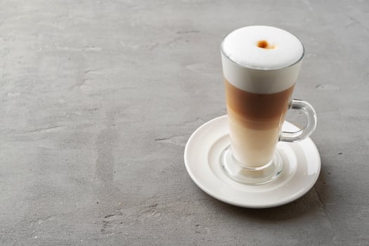 Cup of coffee drink on gray background close up photo