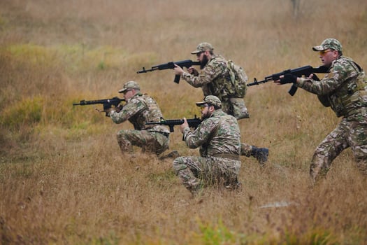 A disciplined and specialized military unit, donned in camouflage, strategically patrolling and maintaining control in a high-stakes environment, showcasing their precision, unity, and readiness for photo