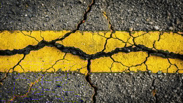 Cracked asphalt road with painted marking photo