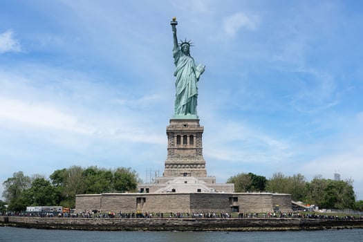 The Statue of Liberty holding her torch on a sunny day in Manhattan photo